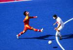 A Chinese blind football player kicks the ball.