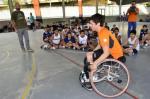 Inge Huitzing, sitting in a wheelchair and playing basketball, visits a school in Brazil