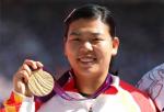 A picture of a chinese woman showing her gold medal