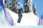 Man on snowboard flies over a jump