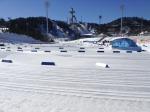 View on a snowy cross-country venue with a ski jump in the background