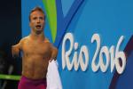 Male swimmer celebrates on pool deck