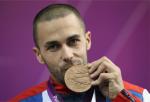 Matthew Skelhon of Great Britain kisses his Bronze medal after competing in the mixed R6-50m Rifle Prone- SH1 final