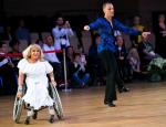 Woman in wheelchair dances with standing male partner 