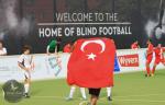 A group of blind football players celebrate a win