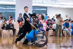 Woman in wheelchair dances with standing partner