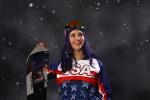 Female snowboarder posses for portrait shot