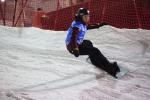 Femanle snowboarder rides a banked slalom