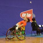 Man in wheelchair playing badminton