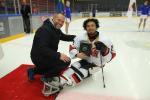 a male Para ice hockey player smiles after being presented with an award