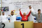 three male powerlifters raise their arms on the podium