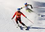 Vision impaired skier and his guide going down a slope