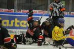 a group of Para ice hockey players celebrate a goal