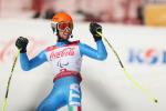 a male Para alpine skier celebrates on the slope