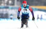 a male Para sit skier crosses the finish line