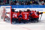 a group of Para ice hockey players huddle before a match