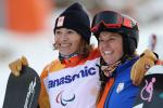two female Para snowboarders hugging