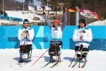 Germany's Andrea Eskau celebrates victory in the women's biathlon 10km sitting at PyeongChang 2018 with silver medallist Neutral Paralympic Athlete Marta Zainullina on the left and bronze medallist Neutral Paralympic Athlete Irina Gulaeva on the right.