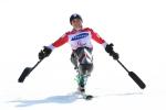a female sit skier celebrates gold 