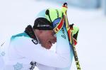 a male sit skier cries on the finish line