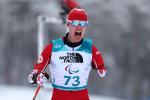 A male Para Nordic skier reacts with delight as he crosses the line