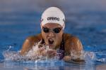 a female Para swimmer comes out of the water to take a breath