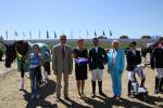 a group of people awarding a Para equestrian rider his medal
