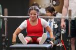 a female powerlifter smiling on the bench