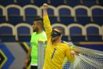 a male goalball player punches the air in celebration