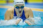a female Para swimmer takes a breath during breaststroke
