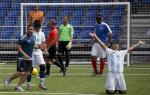 a male blind footballer celebrates on his knees after scoring a goal