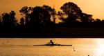 Sunset photo of rower in a boat on the water