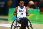 Male wheelchair basketball player shrugs shoulders after scoring