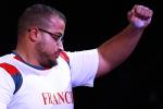 French male powerlifter Rafik Arabat raises his arm to salute the crowd