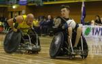 male wheelchair rugby player Cody Everson takes the ball away from another player