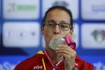 female Para swimmer Teresa Perales kisses a gold medal