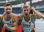 male Para sprinters Felix Streng and Johannes Floors with their arms around eachother cheering