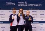 Three women showing her medals