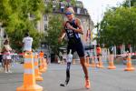 female Para triathlete Liisa Litja running round a corner on the road