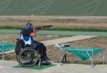 Man in a wheelchair using a shotgun