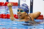 female Para swimmer Yip Pin Xiu punches the air in the pool