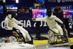 two wheelchair fencers in combat