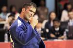 male judoka Ehsan Mousanezhad Karmozdi clenches his fist in victory