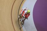 female Para cyclist Emily Lee goes round the track on a tandem cycle