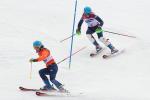 female Para alpine skier Menna Fitzpatrick follows her guide through a slalom gate