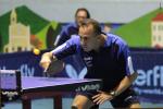 a male intellectually impaired table tennis player plays a backhand across the table