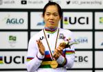 A female Para cyclist applauds on the podium