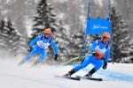 male Para alpine skier Giacomo Bertagnolli follows his guide down the ski slope