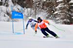 Female Para alpine skier Kelly Gallagher skis round a gate following her guide
