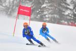 A vision impaired skier following his guide